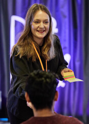 Ida-Britta Petrelius delar ut lappar till publiken under programpunkten hållbar kultur. Foto Linus Lindholm